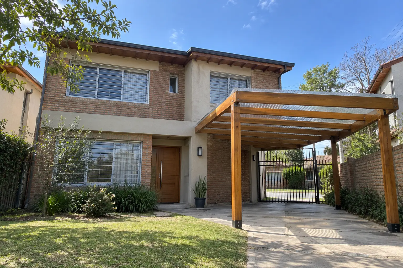 Pérgola de madera para auto al frente de una casa